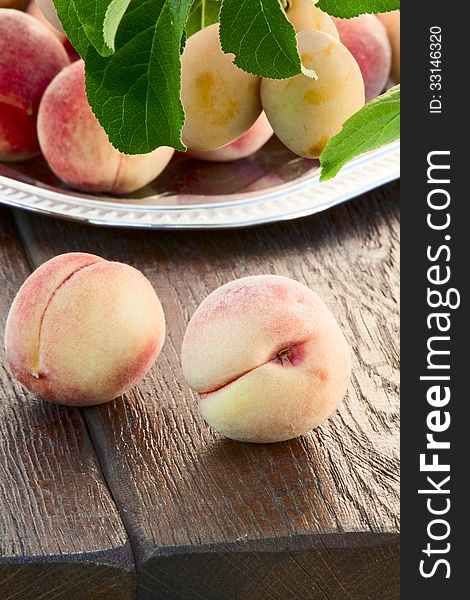 Ripe goldish velvety peaches and yellow plums