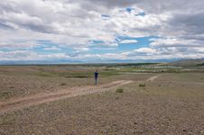 Man Goes Along Dirt Road Steppe Sky Royalty Free Stock Photography