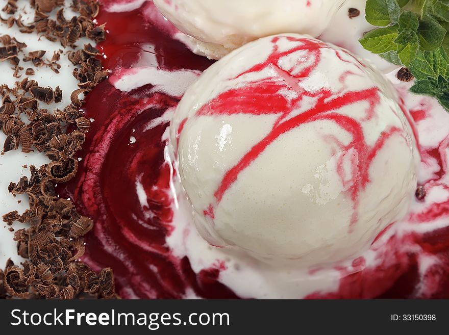 Vanilla ice cream with a sprig of fresh mint syrup and red currant