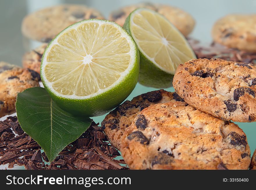 Cookies with chocolate and lemon on a green background. Cookies with chocolate and lemon on a green background