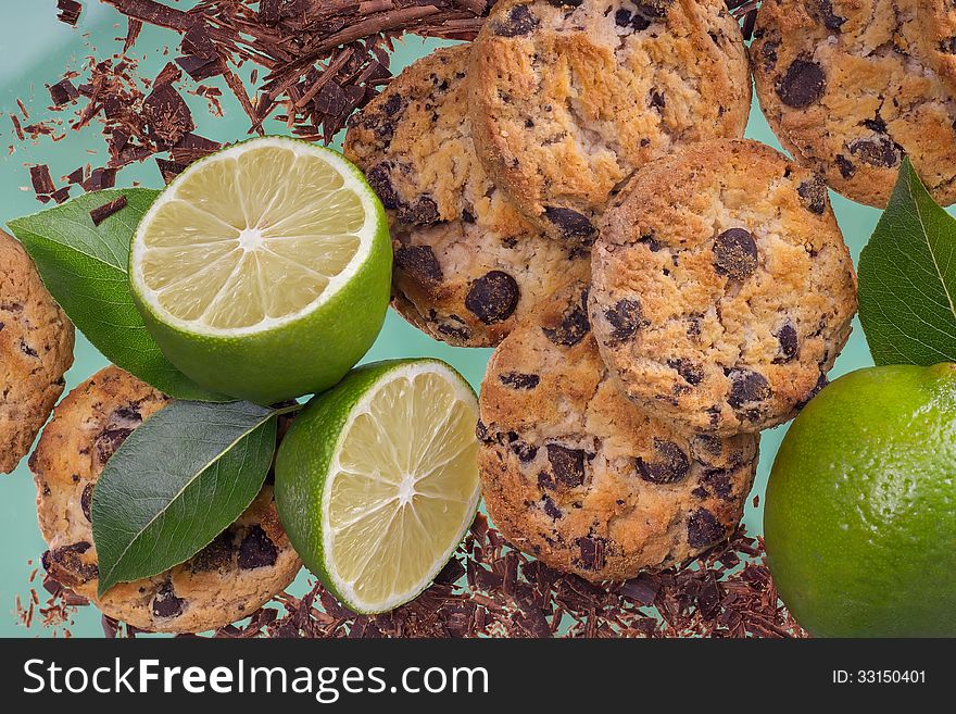 Cookies with chocolate and lemon on a green background. Cookies with chocolate and lemon on a green background