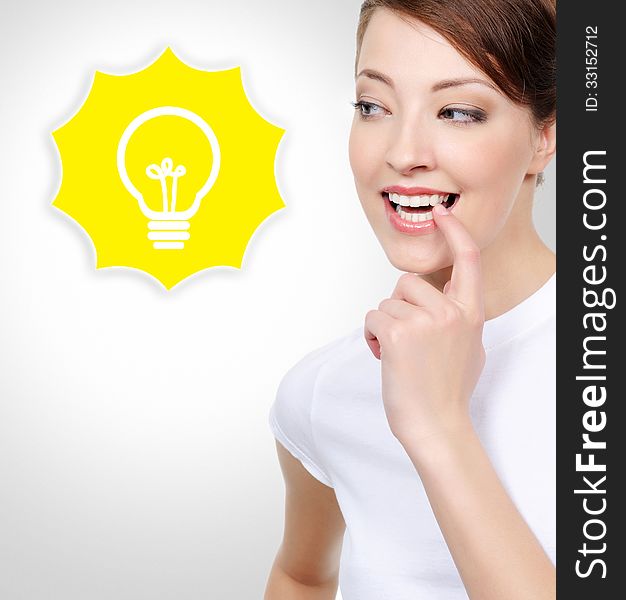 Portrait of beautiful smiling white woman with electric lamp idea concept