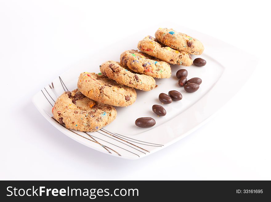 Cookies and chocolate balls on White dish. Cookies and chocolate balls on White dish