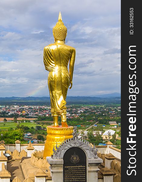 Golden buddha statue under cloudy sky in thailand temple