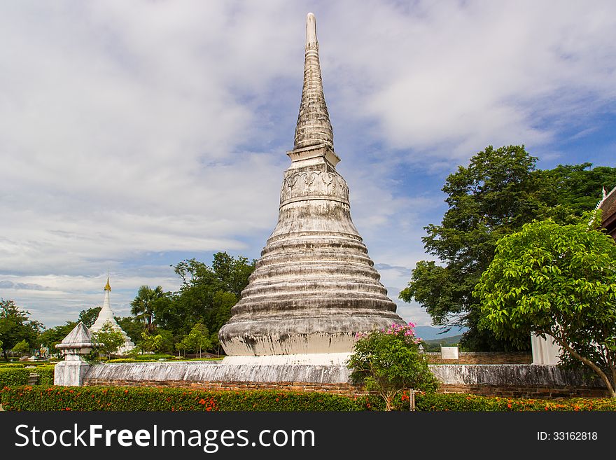 Buddhism white pagoda under cloudy sky in thailand temple. Buddhism white pagoda under cloudy sky in thailand temple
