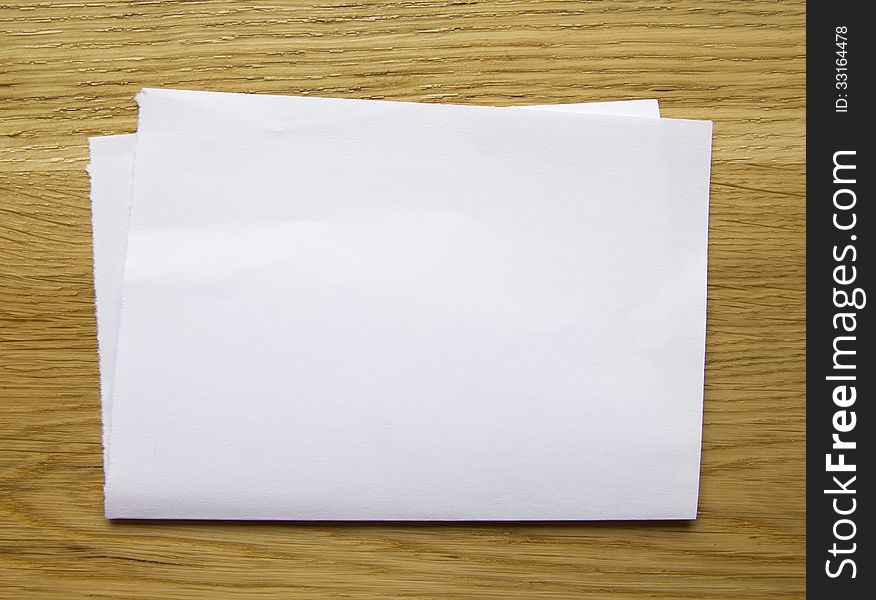 Sheet of blank paper isolated on wooden background