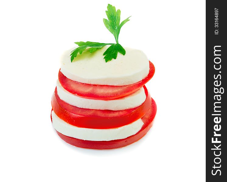 Mozzarella and tomato slices arranged in stack isolated over white. Mozzarella and tomato slices arranged in stack isolated over white