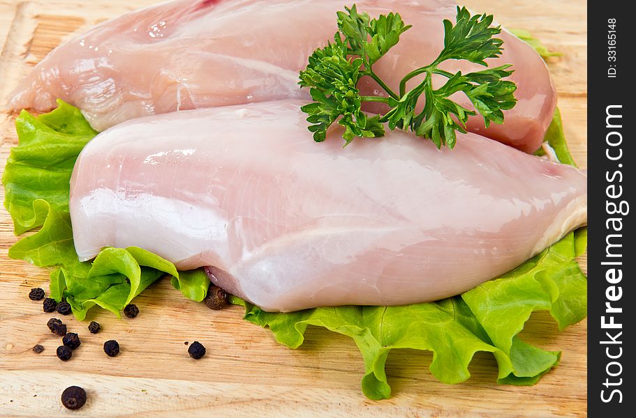 Pair of Chicken breasts on cutting board