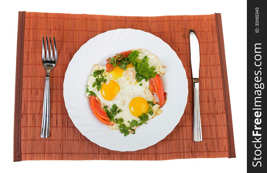 Pair of fried eggs and vegetables on plate