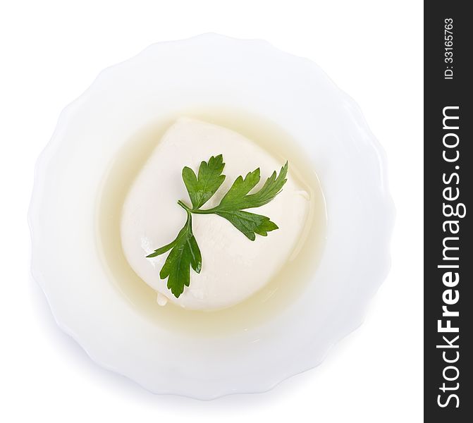 Fresh mozzarella cheese in bowl with whey isolated over white