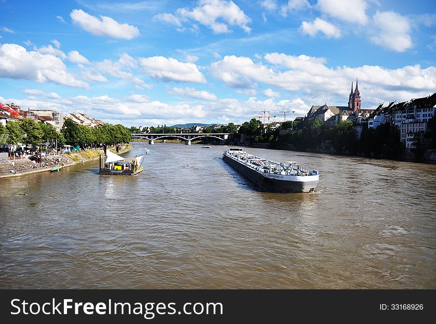 This shot is taken overlooking the River Rhine from one of the many bridges in Basel.Water transport on Rhine river in Basel, Switzerland. This shot is taken overlooking the River Rhine from one of the many bridges in Basel.Water transport on Rhine river in Basel, Switzerland