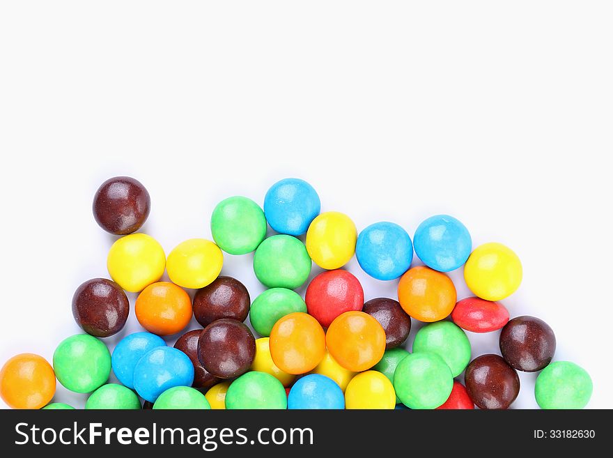 Chocolate balls in colorful glaze are bottom background. Chocolate balls in colorful glaze are bottom background.