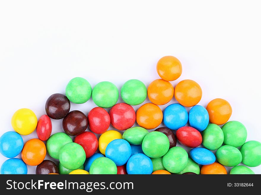 Chocolate balls in colorful glaze are bottom.