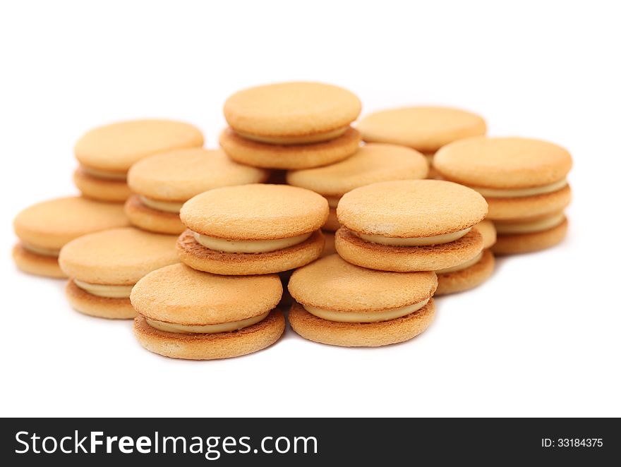 Biscuit sandwich with white filling. Close up. White background.