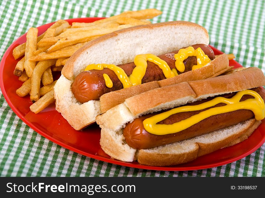 hotdogs with mustard and fries