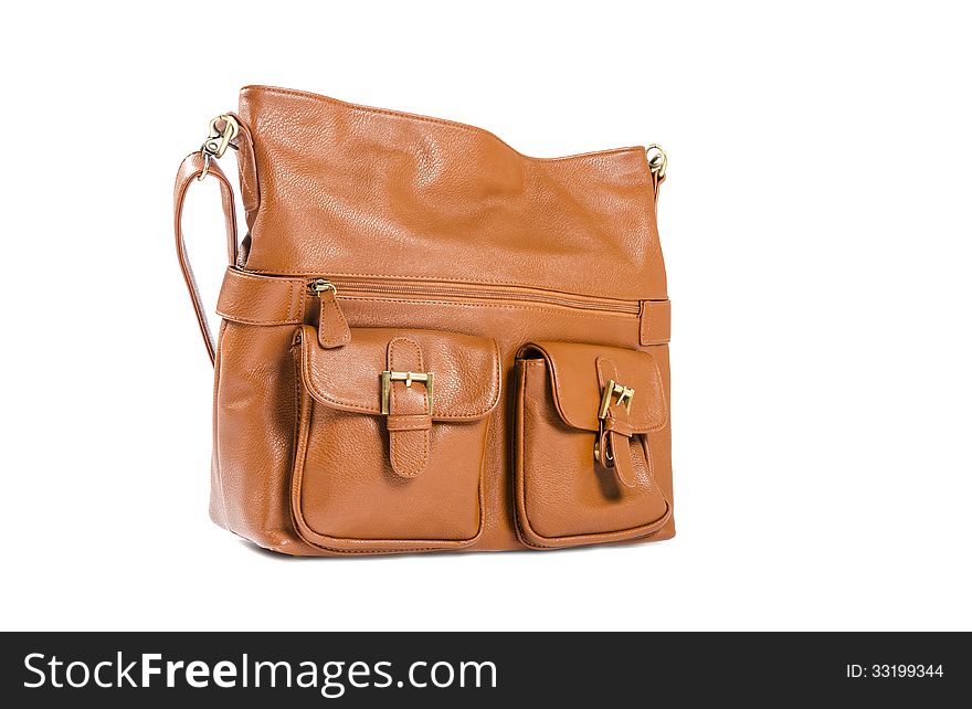 Closeup of a tan colored shoulder bag isolated on white. Closeup of a tan colored shoulder bag isolated on white.
