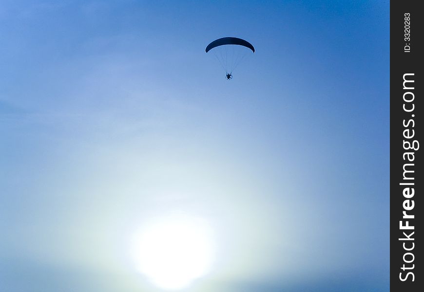 A man paragliding in a peaceful sky