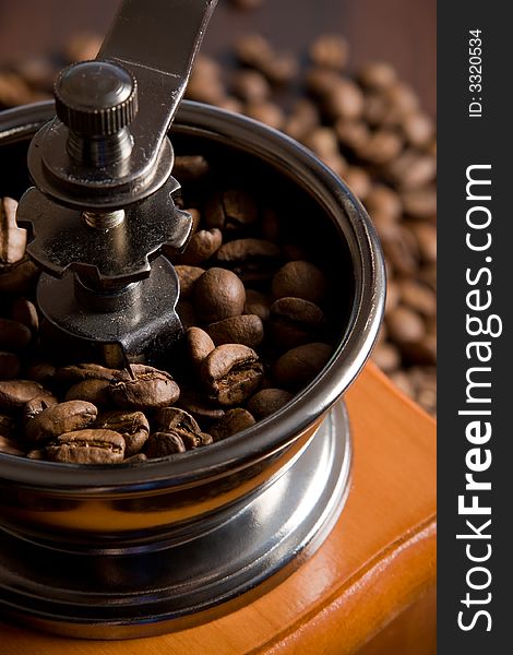 Coffee mill on the background of coffee beans. Coffee mill on the background of coffee beans