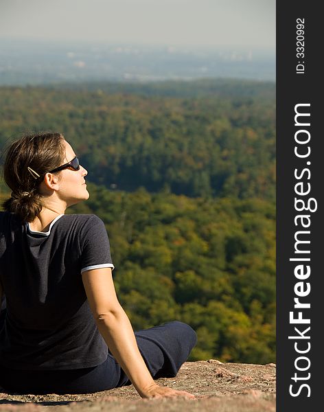 Sitting woman on top of a mountain. Sitting woman on top of a mountain