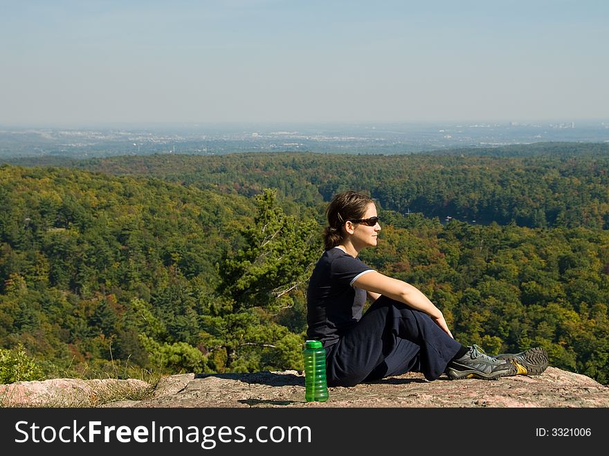 Sitting woman on top of a mountain. Sitting woman on top of a mountain