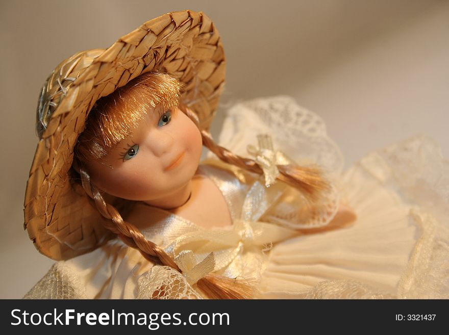 A doll of porcelain with hat and plait. A doll of porcelain with hat and plait