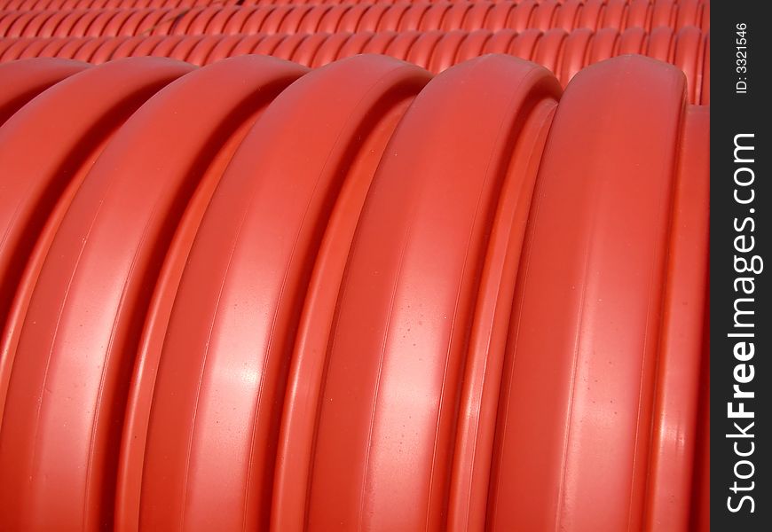 Red pipes with shadow on sunny day