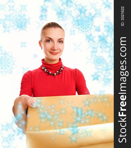 Beautiful blond girl with a gift box and magic snowflakes around her