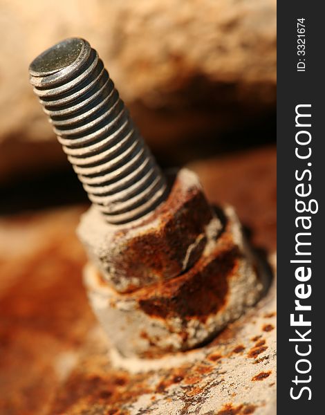 Close-up of rusty bolt of old construction