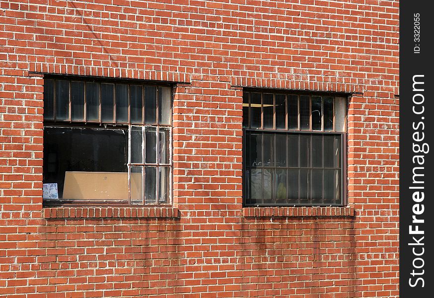 Old brick wall with rusty bars in windows. Old brick wall with rusty bars in windows