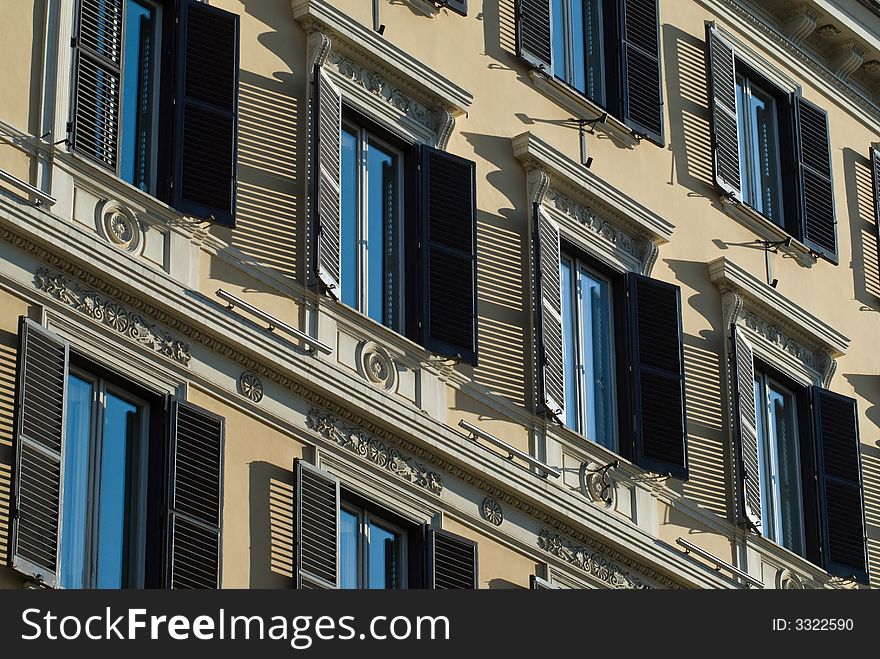 Ornamented facade of  building with shadows. Ornamented facade of  building with shadows