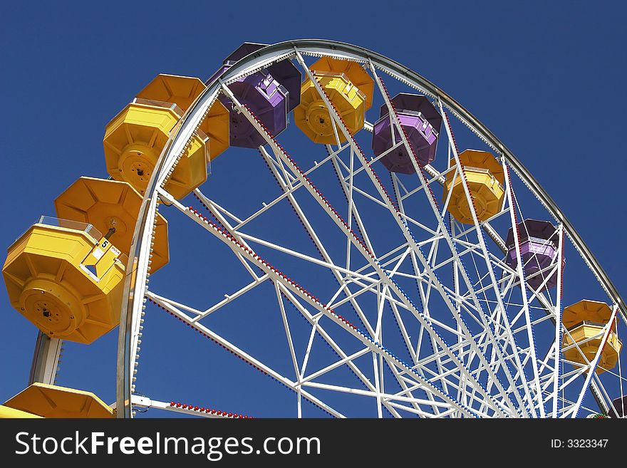Colorful Ferris wheel on a blue sky