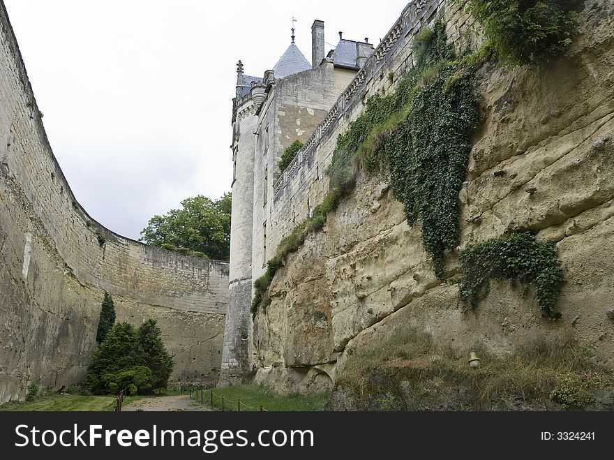 At the bottom of the deep rocky moat of chateau (castle) BreÌzeÌ, Loire Valley, France. At the bottom of the deep rocky moat of chateau (castle) BreÌzeÌ, Loire Valley, France