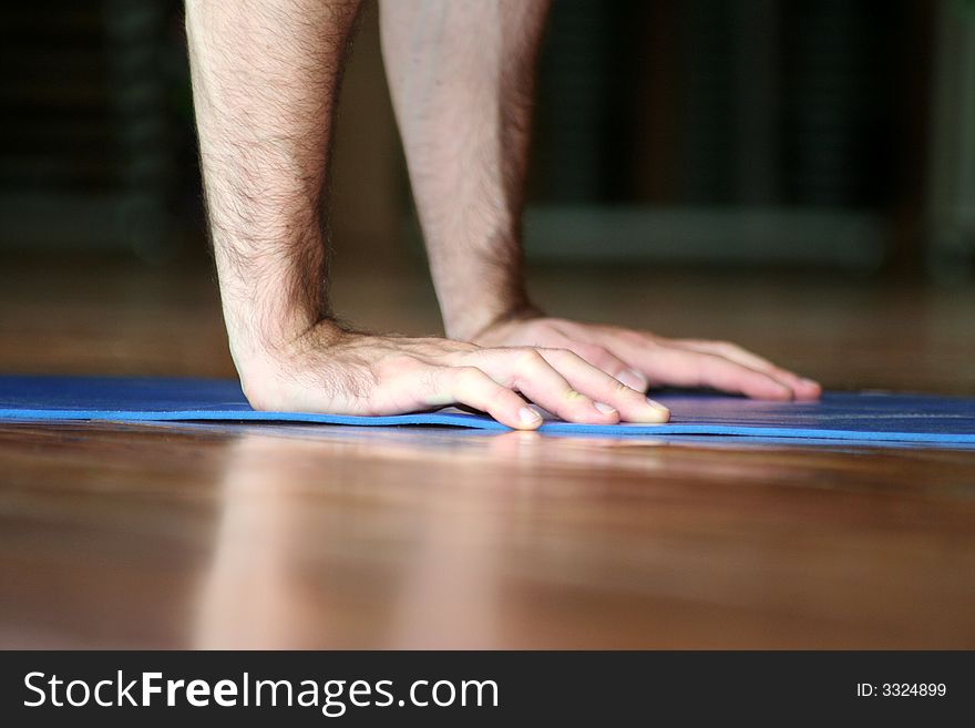 The hands of an athlete while makes the push-up. The hands of an athlete while makes the push-up