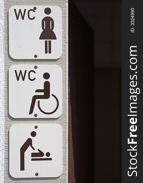 Information signs on housewall for disabled, women and baby change. Information signs on housewall for disabled, women and baby change