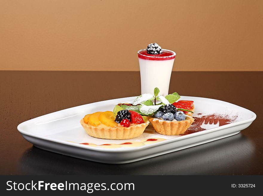 Mixed desert plate with panacotta and summer berries