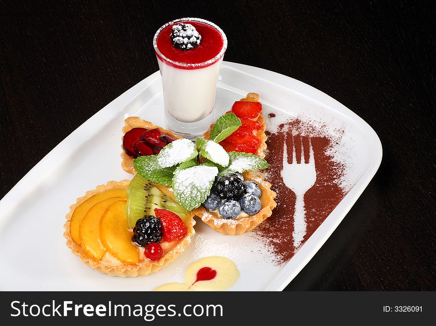 Mixed desert plate with panacotta and summer berries