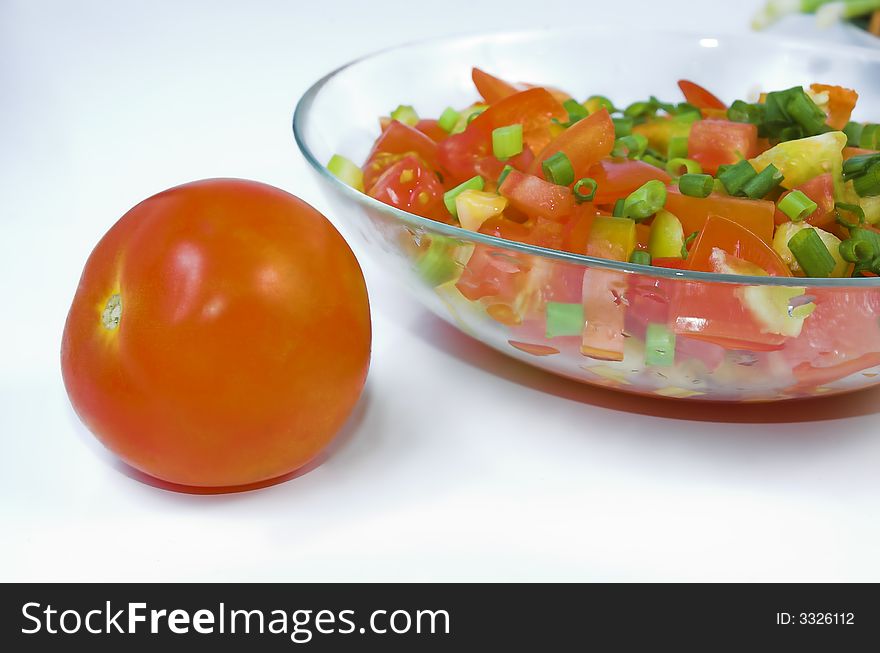 Tomato and salad with an onions close up. Tomato and salad with an onions close up