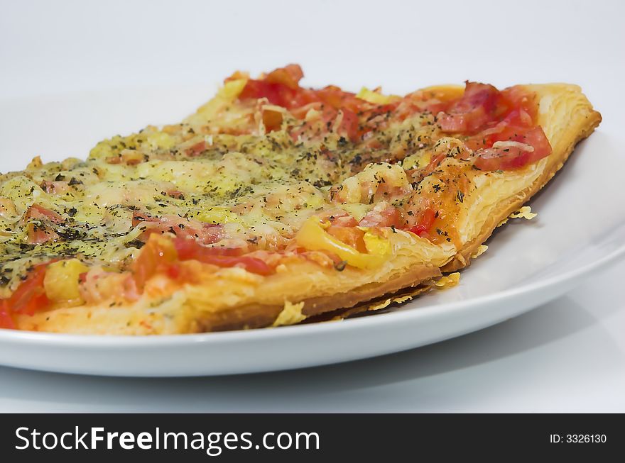 Piece of a pizza close up on a white background