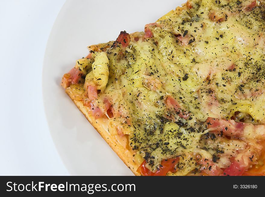 Piece of a pizza close up on a white background