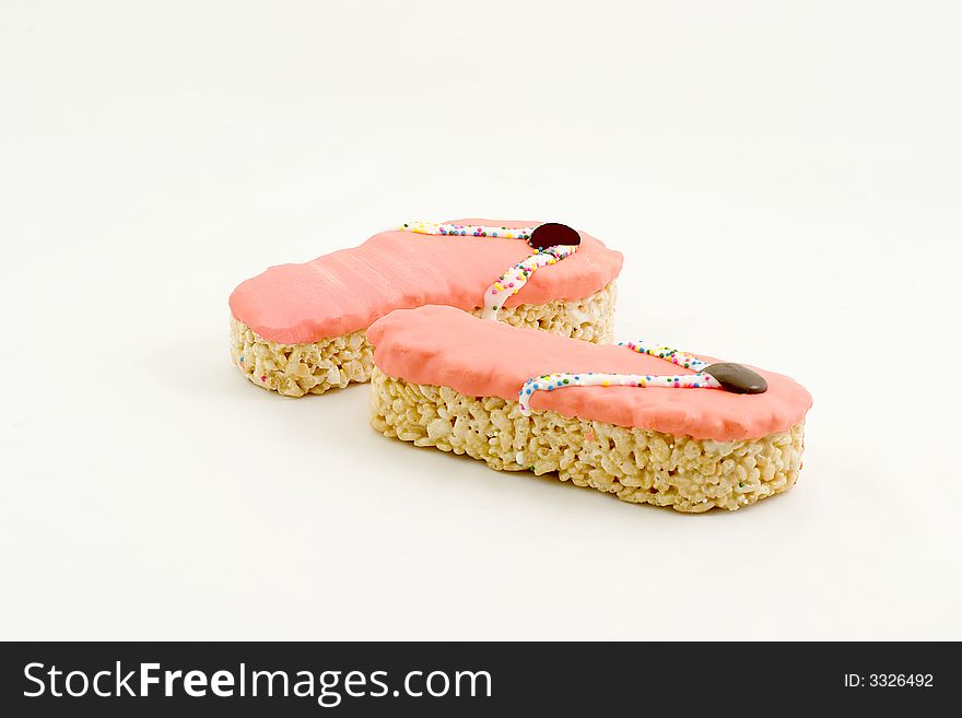 Rice cakes shaped to look like beach sandals, with orange frosting. Rice cakes shaped to look like beach sandals, with orange frosting.