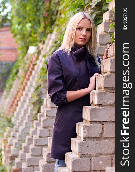 Young woman near brick wall. Young woman near brick wall