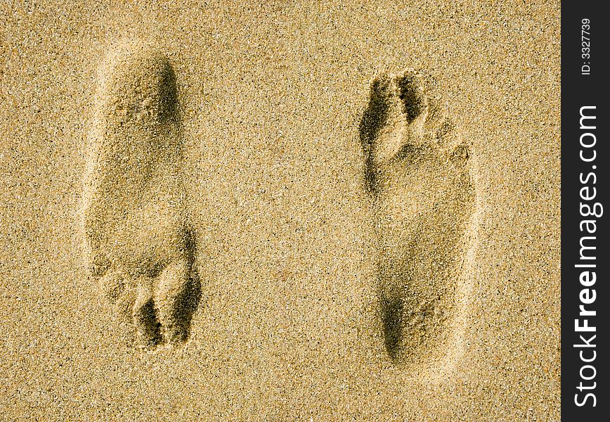 Two illusional footprints on sand. Two illusional footprints on sand