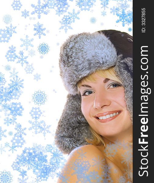 Lovely blond girl in winter fur-cap and abstract snowflakes around her