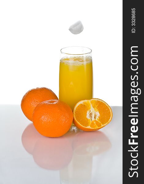 Ice falling in orange juice. Ice falling in orange juice