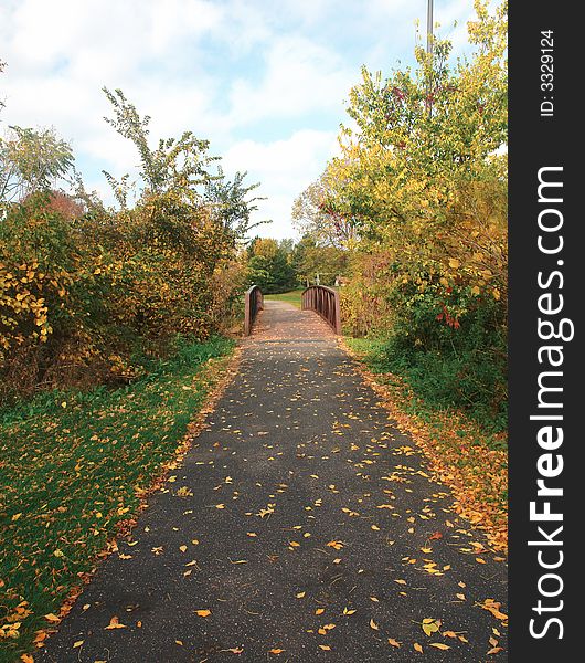 A picture of a beautiful fall scenic of footpath. A picture of a beautiful fall scenic of footpath