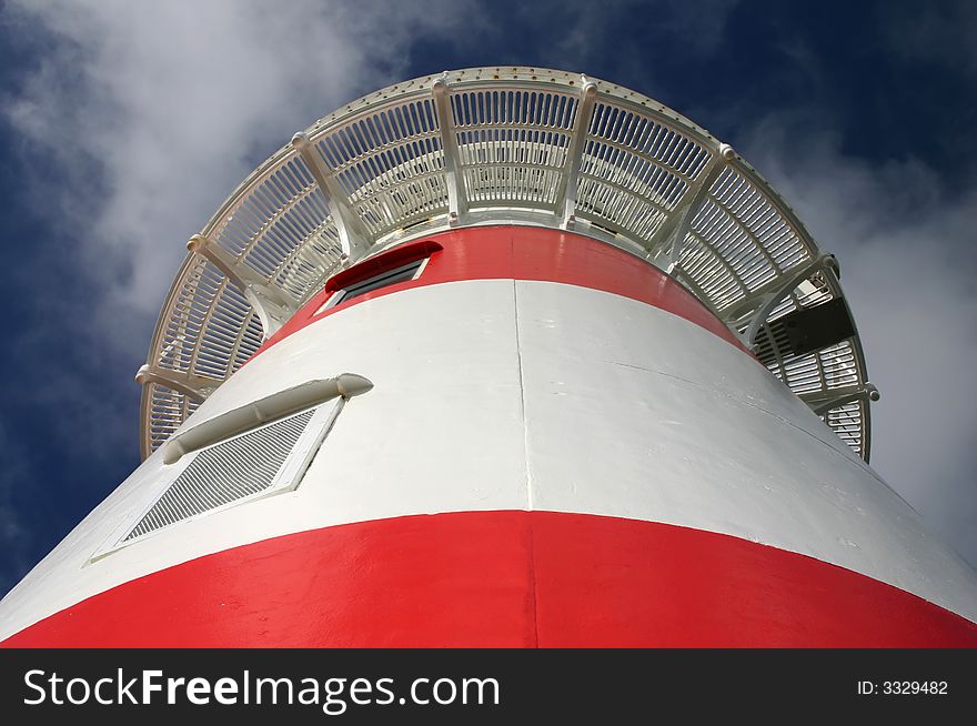 A classical lighthouse. View from the base. Sunny day. A classical lighthouse. View from the base. Sunny day.