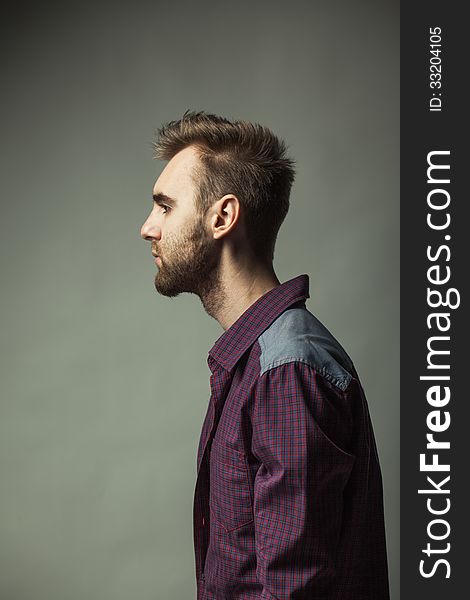 A young adult man on a dark background