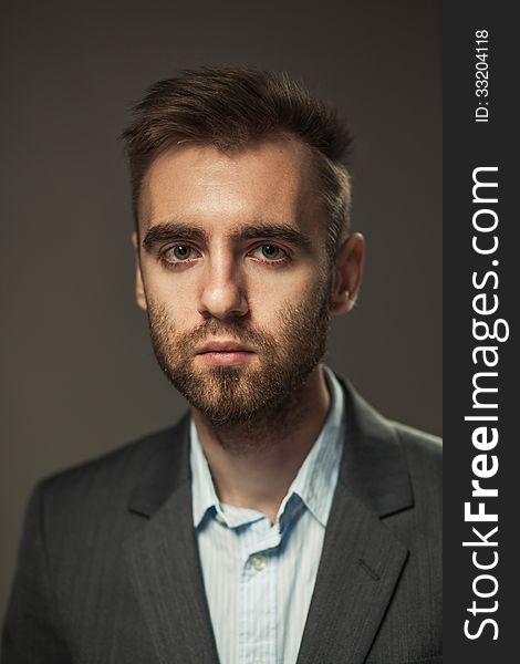 A young businessman on a dark background