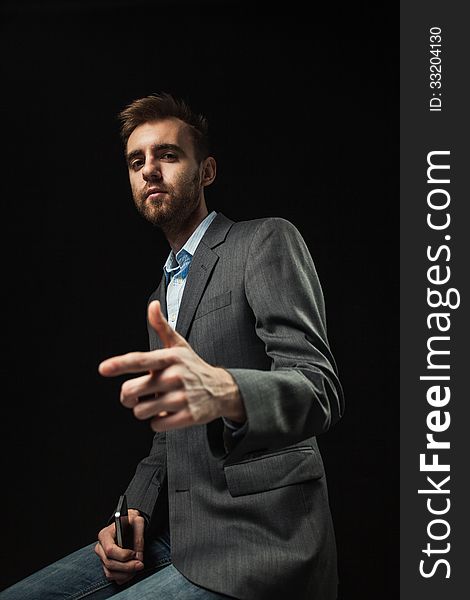 A young businessman on a dark background