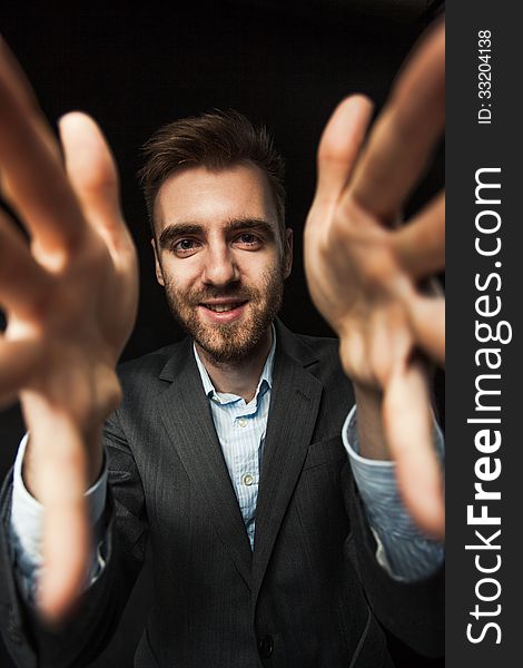 Young Businessman On A Dark Background